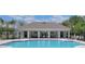 Community pool showcasing a luxurious retreat featuring comfortable lounge seating, covered pavilion, and refreshing clear blue pool waters at 17394 Million Lakes Ct, Clermont, FL 34714