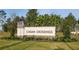 Inviting community entrance sign set amidst lush landscaping, creating a welcoming atmosphere at 17394 Million Lakes Ct, Clermont, FL 34714