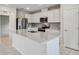 Bright kitchen features an island, stainless steel appliances, and white cabinets at 17394 Million Lakes Ct, Clermont, FL 34714