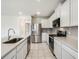 Clean kitchen features stainless steel appliances, white cabinets, and tile flooring at 17394 Million Lakes Ct, Clermont, FL 34714