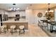 Modern kitchen with stainless steel appliances, a spacious island with bar seating, and open dining area at 17394 Million Lakes Ct, Clermont, FL 34714
