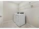Laundry room with tile floor and white washer and dryer at 17394 Million Lakes Ct, Clermont, FL 34714