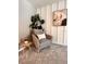 Comfortable chair with an accent table with decor and a neutral color palette creating a peaceful retreat at 17394 Million Lakes Ct, Clermont, FL 34714