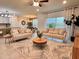 Open-concept living room featuring neutral furnishings, stylish decor, and ample natural light at 17394 Million Lakes Ct, Clermont, FL 34714