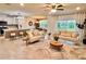 Open-concept living room featuring neutral furnishings, stylish decor, and ample natural light at 17394 Million Lakes Ct, Clermont, FL 34714