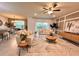 Open-concept living room featuring neutral furnishings, stylish decor, and ample natural light at 17394 Million Lakes Ct, Clermont, FL 34714