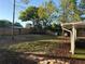 A spacious backyard with green grass, a tree, privacy fence, trampoline, and basketball hoop at 17411 Hillside Dr, Montverde, FL 34756