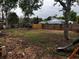 Large backyard featuring mature trees, a wooden fence, and a playset at 17411 Hillside Dr, Montverde, FL 34756