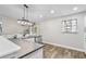 Bright kitchen area featuring modern lighting, stainless steel appliances and gray countertops at 17411 Hillside Dr, Montverde, FL 34756