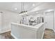 Bright kitchen area featuring modern lighting, stainless steel appliances and gray countertops at 17411 Hillside Dr, Montverde, FL 34756