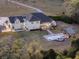 Aerial view of home with pool, enclosed patio and gazebo, surrounded by manicured lawns and mature trees at 1814 Old Stable Pt, Chuluota, FL 32766