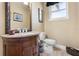 Chic half bathroom with granite vanity, decorative mirror, and stylish fixtures at 1814 Old Stable Pt, Chuluota, FL 32766