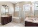 Primary bathroom includes dual vanities, soaking tub, and tiled shower at 1814 Old Stable Pt, Chuluota, FL 32766