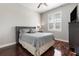 Cozy bedroom with wood floors, and a grey upholstered headboard at 1814 Old Stable Pt, Chuluota, FL 32766