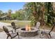 Cozy outdoor fire pit with seating area, perfect for gathering and enjoying evenings in this well-manicured backyard at 1814 Old Stable Pt, Chuluota, FL 32766