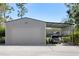 Spacious detached garage with carport extension, perfect for vehicle storage and other projects at 1814 Old Stable Pt, Chuluota, FL 32766