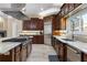 Beautiful kitchen with stainless steel appliances, a large island, and dark wood cabinetry at 1814 Old Stable Pt, Chuluota, FL 32766