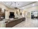 Open concept living room featuring a stone fireplace, tray ceiling, and ample natural light at 1814 Old Stable Pt, Chuluota, FL 32766