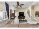 Cozy living room showcasing a stone fireplace, tray ceilings, and seamless flow to other living spaces at 1814 Old Stable Pt, Chuluota, FL 32766