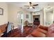 Warm living room showcasing hardwood floors, comfortable seating, and natural light at 1814 Old Stable Pt, Chuluota, FL 32766