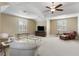 Spacious living room features a tray ceiling, neutral carpet, and furniture at 1814 Old Stable Pt, Chuluota, FL 32766