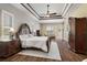 Serene main bedroom featuring tray ceilings, wood floors, and a cozy seating area at 1814 Old Stable Pt, Chuluota, FL 32766