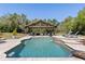 Inviting pool area features a covered patio, stone pavers, lounge chairs, and mature landscaping, perfect for outdoor relaxation at 1814 Old Stable Pt, Chuluota, FL 32766