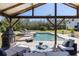 Enjoy this backyard featuring a sparkling pool, covered patio, and lounge seating, creating a serene outdoor oasis at 1814 Old Stable Pt, Chuluota, FL 32766