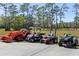 View of the orange tractor, golf cart, riding lawn mower and green 4-wheeler at 1814 Old Stable Pt, Chuluota, FL 32766