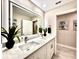 Modern bathroom featuring double sinks, a large illuminated mirror, and stylish finishes at 2012 Dorris Dr, Orlando, FL 32807