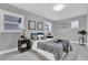 Neutral bedroom featuring a bed with gray linens, two side tables, and plenty of natural light at 2012 Dorris Dr, Orlando, FL 32807