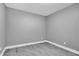 An empty bedroom with wood-look floors, gray walls, white trim and baseboards at 2012 Dorris Dr, Orlando, FL 32807