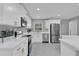 Modern white kitchen with stainless steel appliances and quartz countertops at 2012 Dorris Dr, Orlando, FL 32807