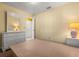 Sunny bedroom with large dresser and view to en-suite bathroom at 2030 Royal Bay Blvd # 62, Kissimmee, FL 34746