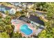 Aerial view of a community pool with lounge chairs and nearby condos surrounded by green space at 2030 Royal Bay Blvd # 62, Kissimmee, FL 34746