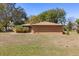 Expansive backyard highlighting the home's exterior, green lawn, and mature trees at 209 Camden Rd, Altamonte Springs, FL 32714