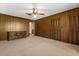 Spacious carpeted bedroom features paneled walls, ceiling fan, closet, and wooden dresser at 209 Camden Rd, Altamonte Springs, FL 32714