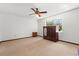 Simple bedroom featuring a ceiling fan, large window, carpeted floor, and traditional furnishings at 209 Camden Rd, Altamonte Springs, FL 32714