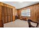 Wood-paneled bedroom with carpet, window, and storage at 209 Camden Rd, Altamonte Springs, FL 32714