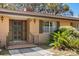 Inviting front entry with stylish wood door, brick accents, and lush landscaping at 209 Camden Rd, Altamonte Springs, FL 32714