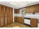 Functional kitchen with wood cabinetry, bright lighting, and complementary tile flooring at 209 Camden Rd, Altamonte Springs, FL 32714