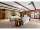 Comfortable living room featuring wood beams, stone fireplace, and a cozy seating area at 209 Camden Rd, Altamonte Springs, FL 32714