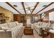 Inviting living room featuring a stone fireplace, wood beams, and comfortable seating at 209 Camden Rd, Altamonte Springs, FL 32714