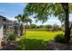 Spacious backyard with a screened-in patio, lush lawn and a cozy fire pit area at 2106 Ridgewind Way, Windermere, FL 34786