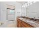 Bathroom featuring double sinks with granite countertops, vanity, and walk-in shower at 2106 Ridgewind Way, Windermere, FL 34786