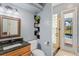 Modern bathroom with granite countertop, decorative shelving, and a glass door shower leading to the screened patio at 2106 Ridgewind Way, Windermere, FL 34786