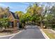 Stone guard house at gated community entrance with iron gate and mature trees at 2106 Ridgewind Way, Windermere, FL 34786