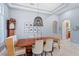 Chic dining room with a wooden table, neutral chairs, and stylish decor in a well-lit space at 2106 Ridgewind Way, Windermere, FL 34786