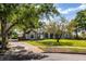 Charming single-story home with lush landscaping, stone accents, and a welcoming front yard at 2106 Ridgewind Way, Windermere, FL 34786