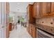 A view of the kitchen with stainless appliances, granite countertops and a view of an outdoor dining area at 2106 Ridgewind Way, Windermere, FL 34786